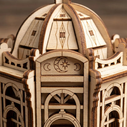 Close-up of the engraved crescent moon and star emblem on an architectural miniature of laser cut plywood.