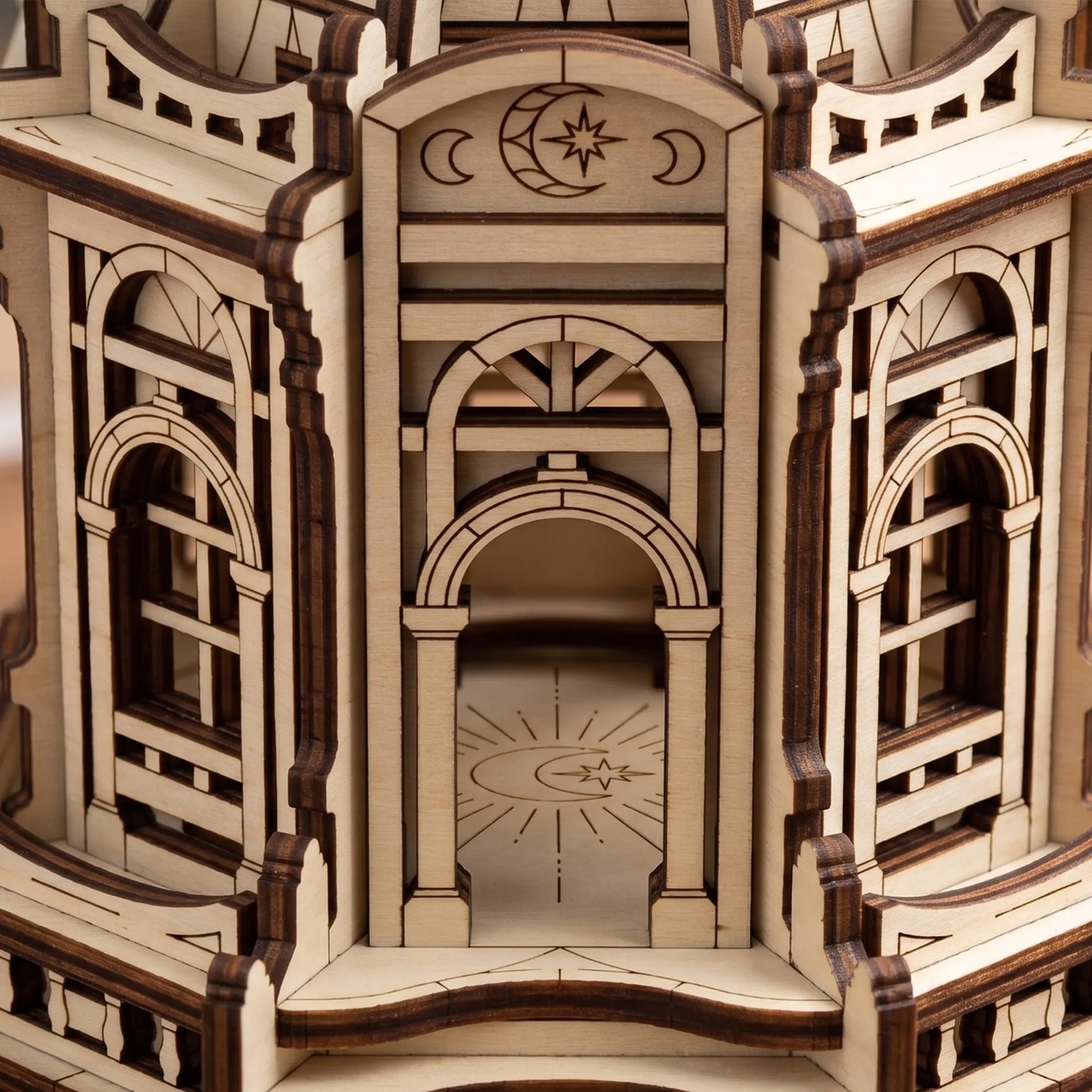 Macro shot of the main archway and engraved floor details inside a layered laser cut plywood temple building.