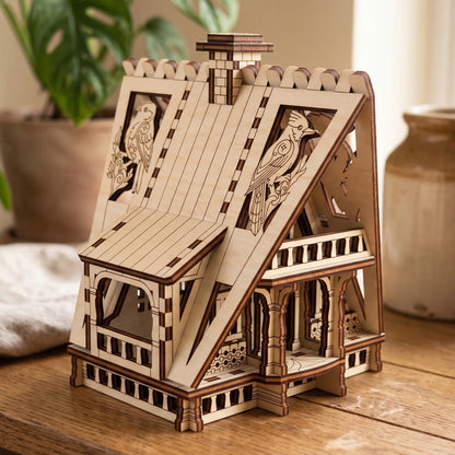Side angle view of an assembled miniature forest cottage with bird carvings made of premium laser cut plywood.