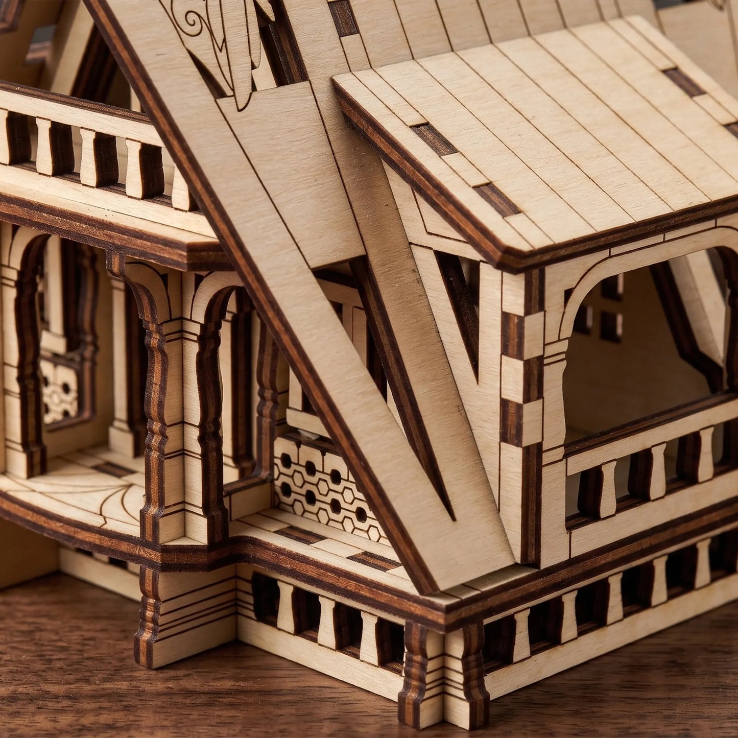 Close-up view showing the veranda pillars and delicate window frames of a laser cut plywood fairy house model.