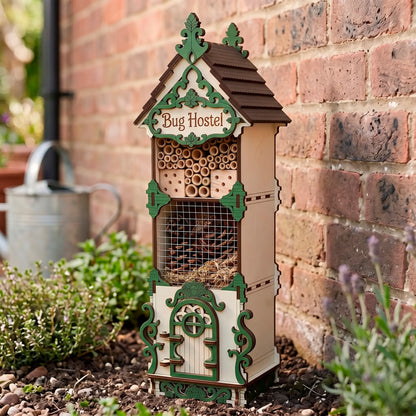 Laser-cut birch plywood bug hostel placed outdoors near a brick wall, filled with natural materials and green decorative accents.