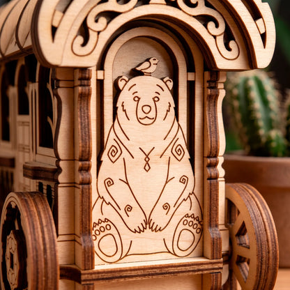 A crisp macro close-up of a laser-cut plywood fairy cart featuring a precisely engraved cute bear illustration with a bird.