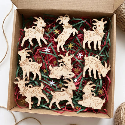 Craft gift box filled with paper filler and complete set of laser cut plywood goat ornaments with engraved patterns.