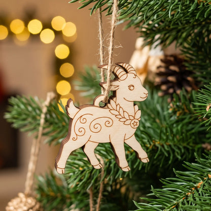 Laser cut plywood walking goat ornament with engraved patterns hanging on a natural Christmas tree with holiday lights.