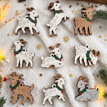 Set of painted laser cut plywood Christmas goat ornaments lying on fluffy white blanket with golden holiday star confetti.