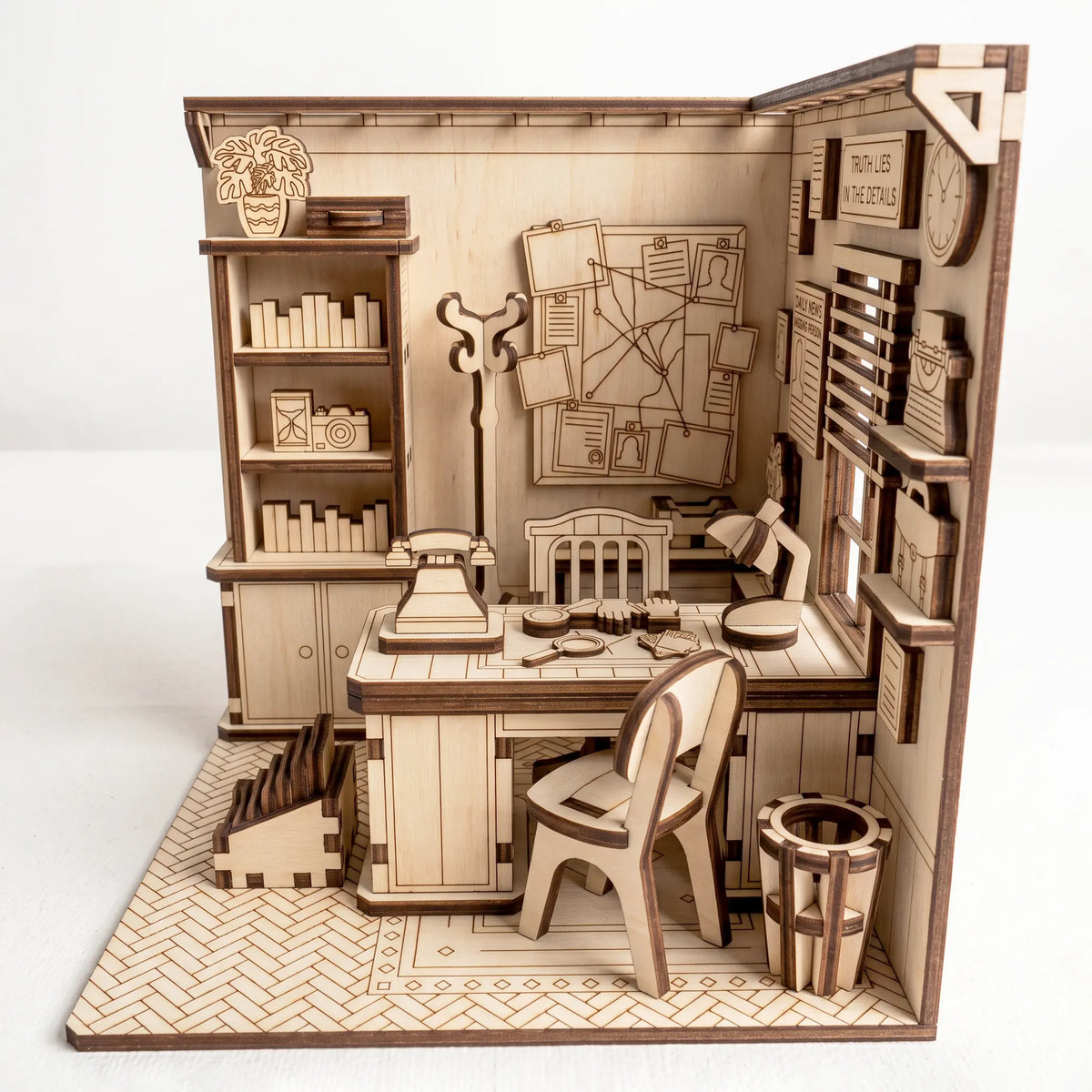 Front view of laser cut plywood detective office book nook model featuring desk, evidence board, bookcase, and retro phone.