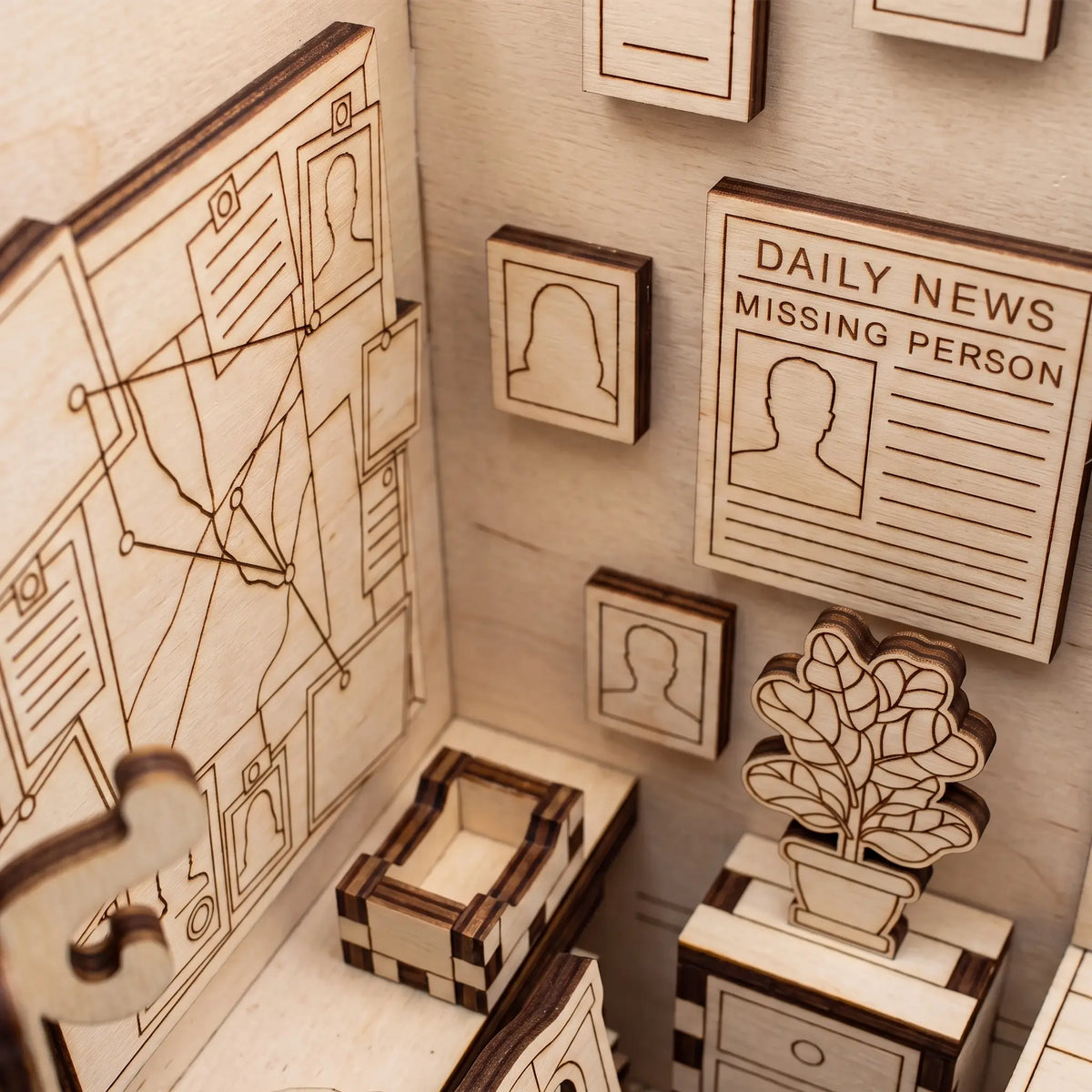 Detailed view of laser cut plywood detective office book nook showing miniature investigation board and missing person news