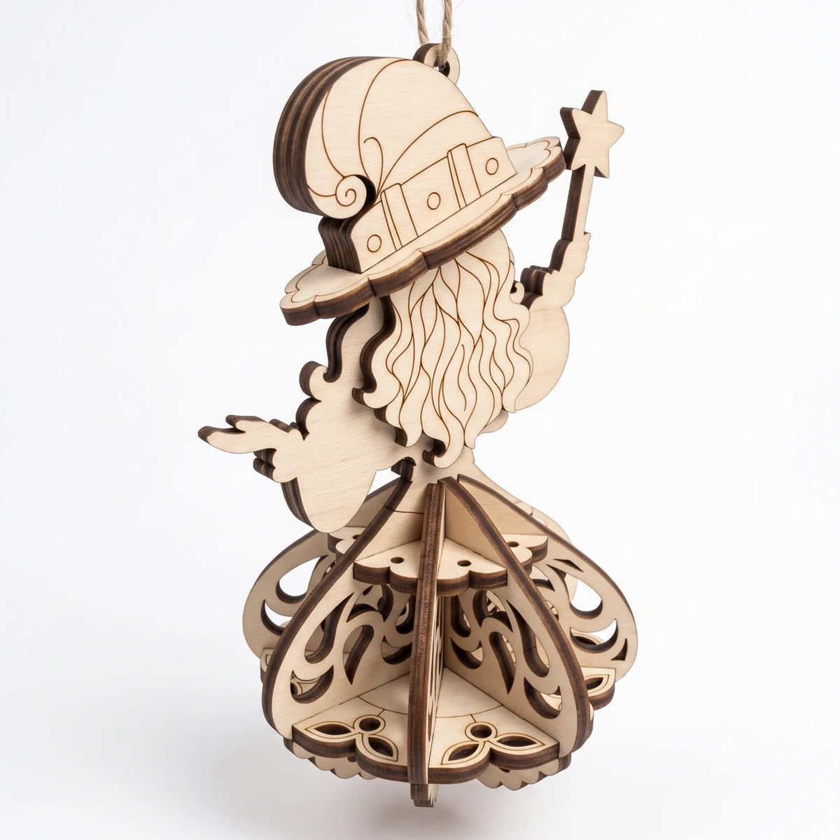 Back angle view of laser cut plywood witch figurine holding star wand, showing layered 3D skirt on white background.