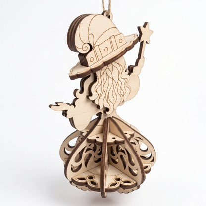 Back angle view of laser cut plywood witch figurine holding star wand, showing layered 3D skirt on white background.