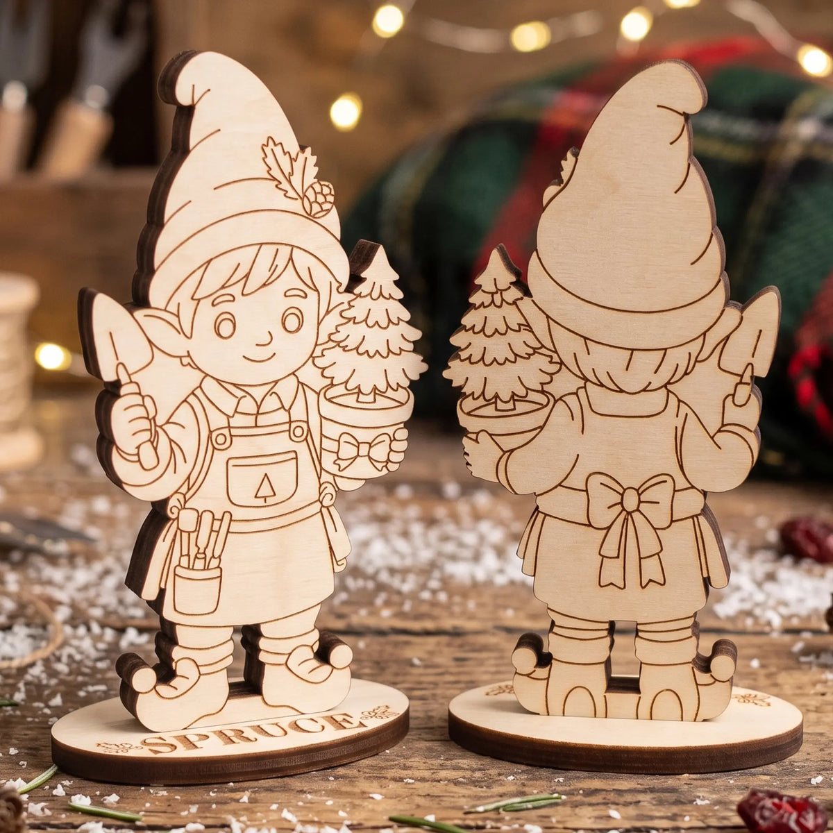 Front and back view of unpainted laser cut plywood gardener elf Spruce holding small potted pine on wood.
