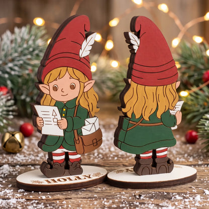 Front and back view of painted laser cut plywood post elf Holly holding letter on snowy rustic surface.