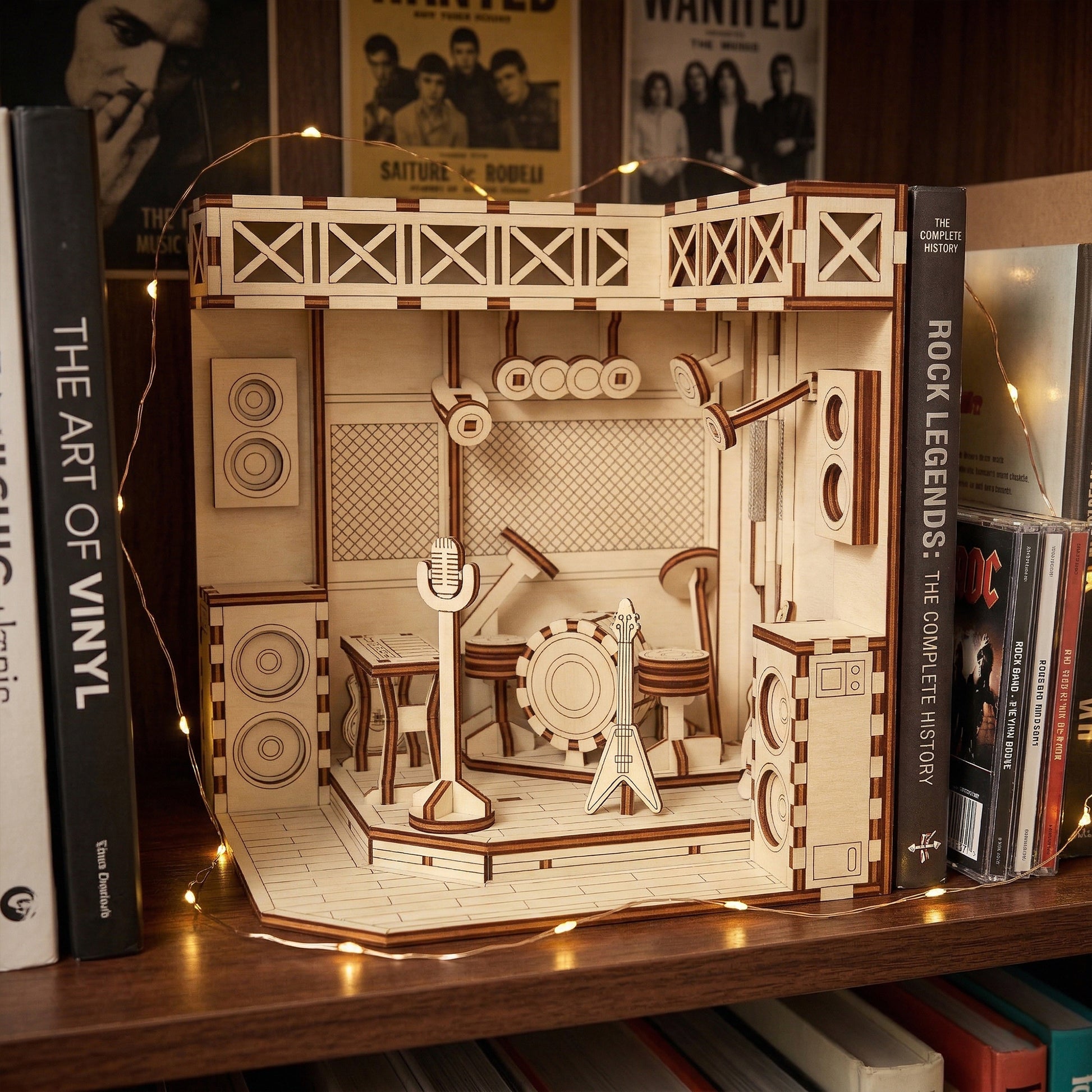Wooden book nook laser cut model of a music-themed room on a shelf with books around