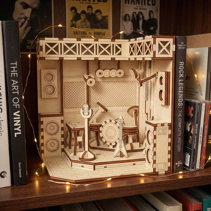 Wooden book nook laser cut model of a music-themed room on a shelf with books around