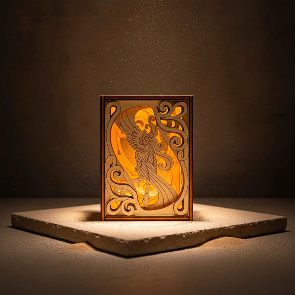 Harpy laser cut book nook with a glowing central design on a dark background