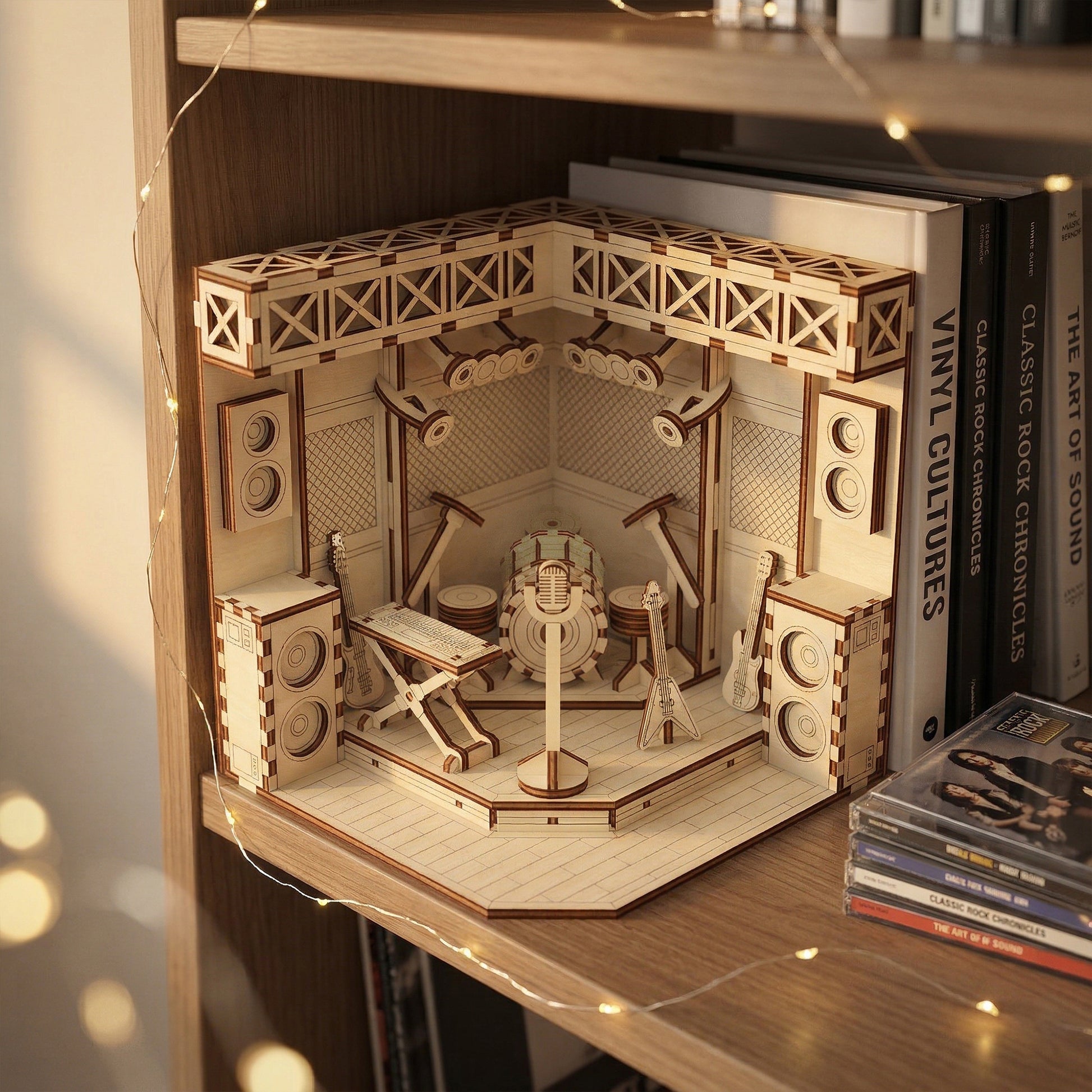 Wooden laser cut booknook of a radio studio on a shelf with books around