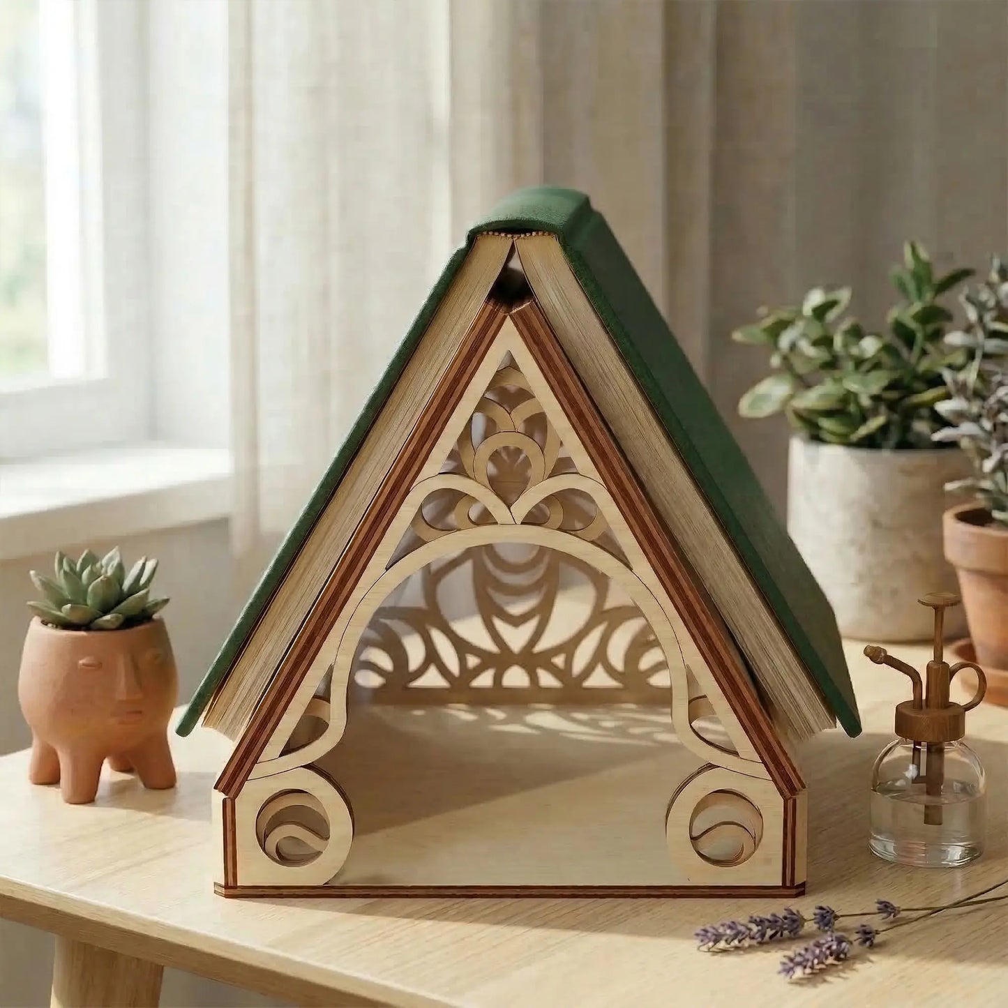 Wooden laser cut greenhouse book holder with decorative design on a table with plants in the background
