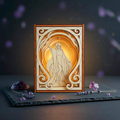 Decorative laser cut box with a stylized illustration of a woman in a frame, surrounded by mystical elements on a dark background.