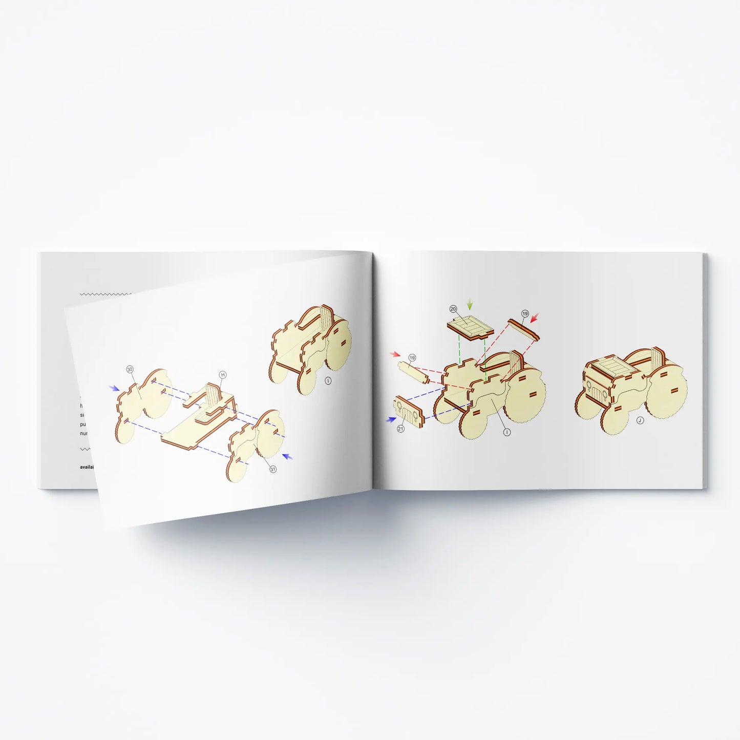 Open printed instruction manual showing 3D step diagrams to build a toy vehicle from laser cut plywood elements.