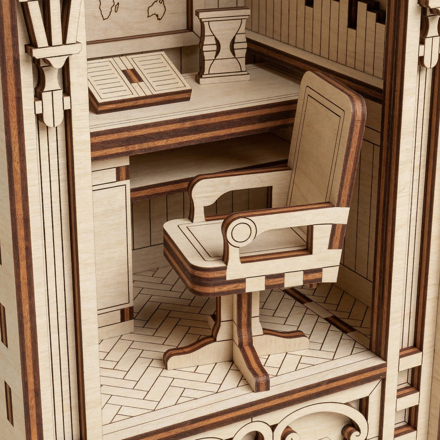 Wooden laser cut model of a room with a desk and chair