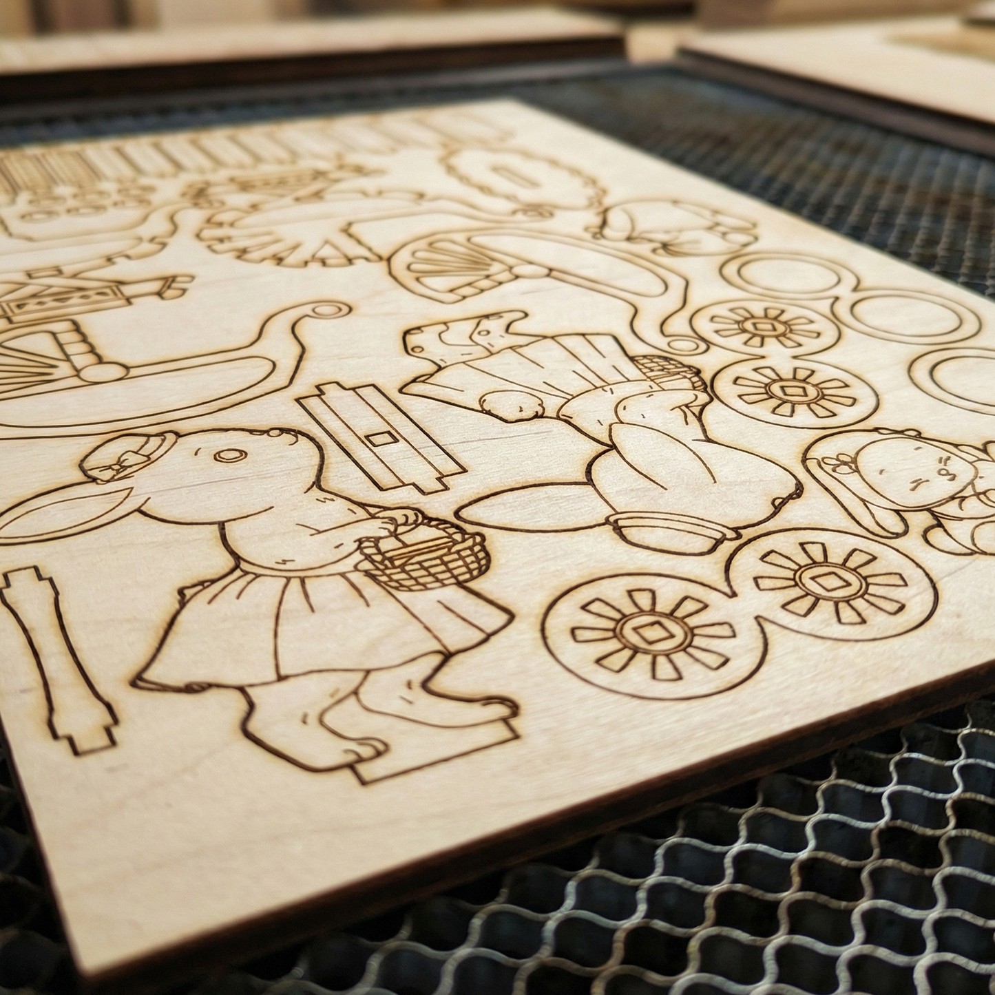 Wooden cutout with laser-engraved design of a fairy tale scene on a grid surface.