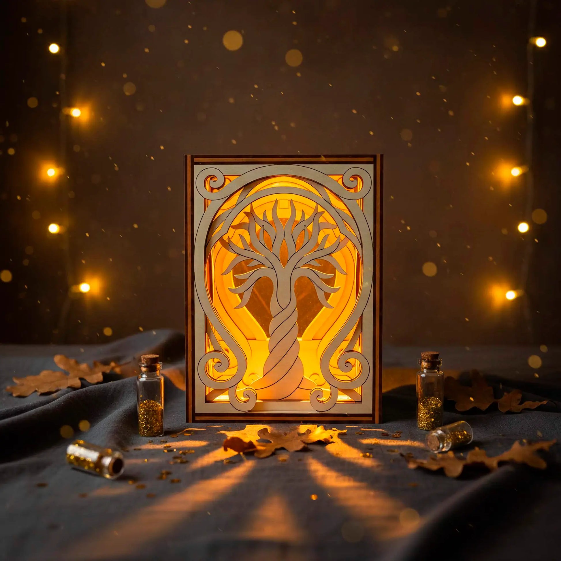 Decorative laser cut lamp with tree design on a dark background with lights
