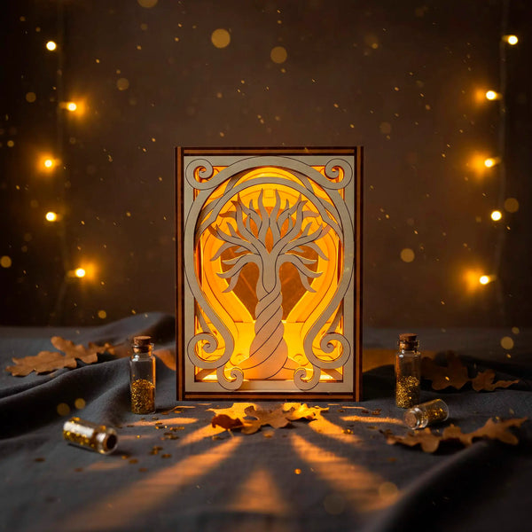 Decorative laser cut lamp with tree design on a dark background with lights