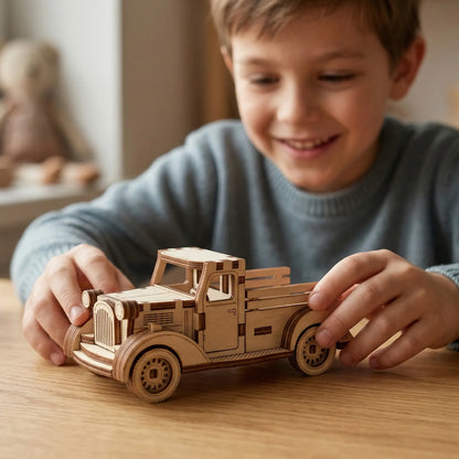 Child playing with a wooden laser cut toy truck on a table