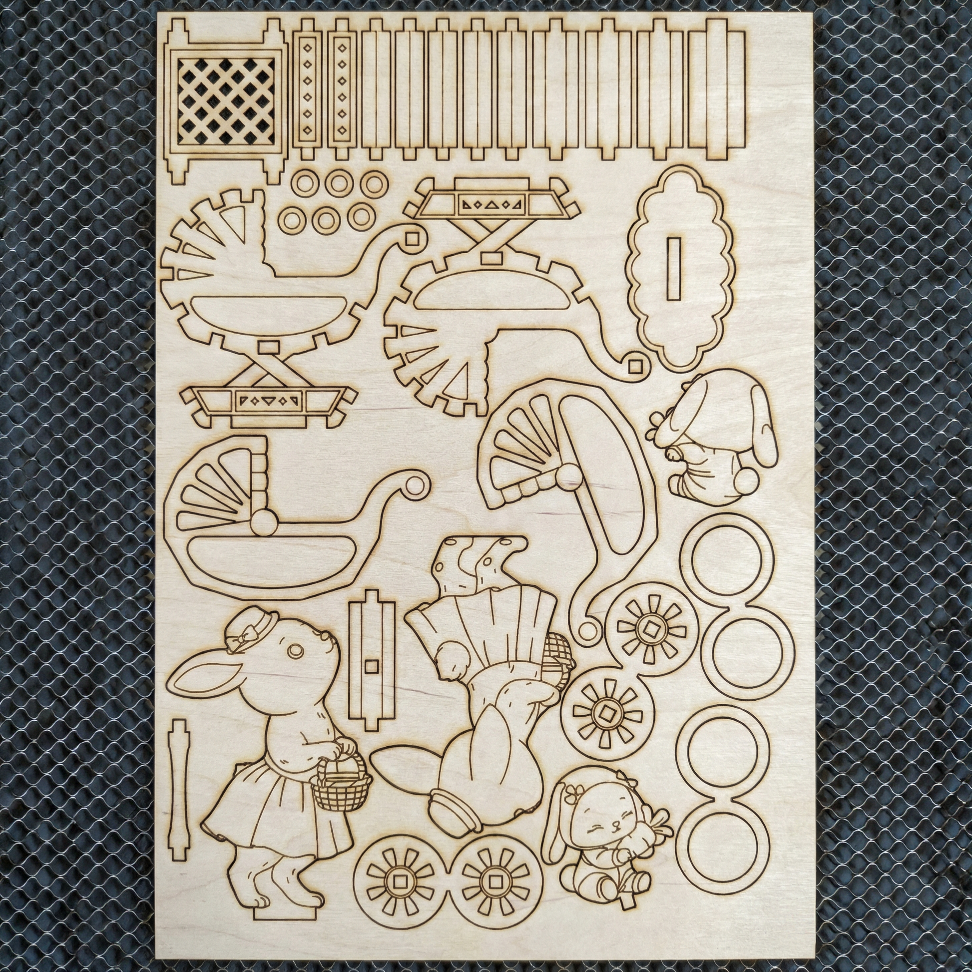 Wooden laser cutout shapes with various designs on a textured black surface