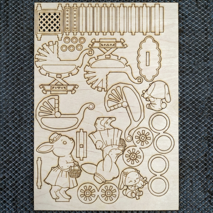 Wooden laser cutout shapes with various designs on a textured black surface