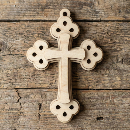 Wooden laser cut cross on a rustic wooden background
