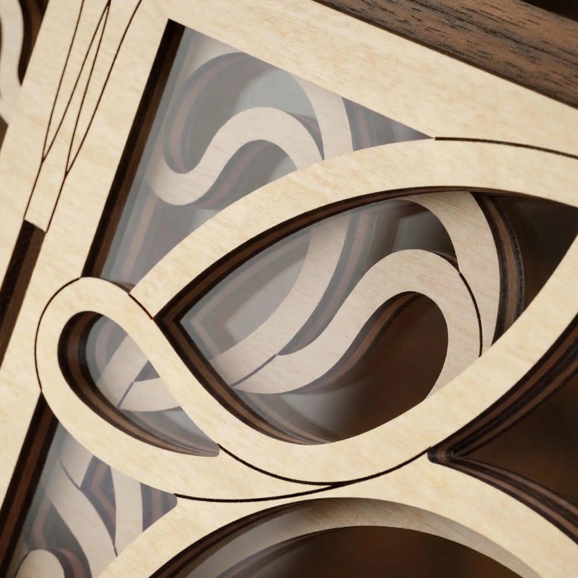 Close-up of a wooden laser cut decorative panel with intricate cut-out patterns