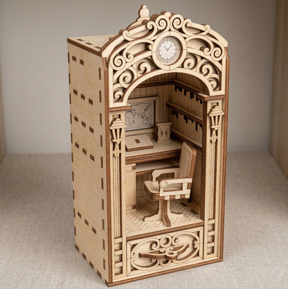 Wooden book nook laser cut model of a room with intricate carvings and a clock on a neutral background