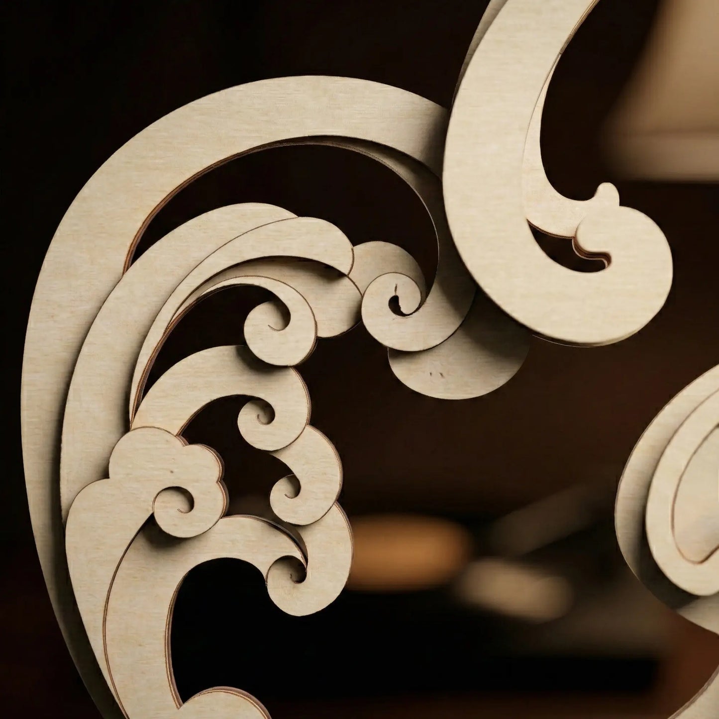 Decorative wooden carvings with intricate patterns on a dark background
