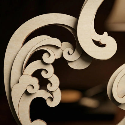 Decorative wooden carvings with intricate patterns on a dark background