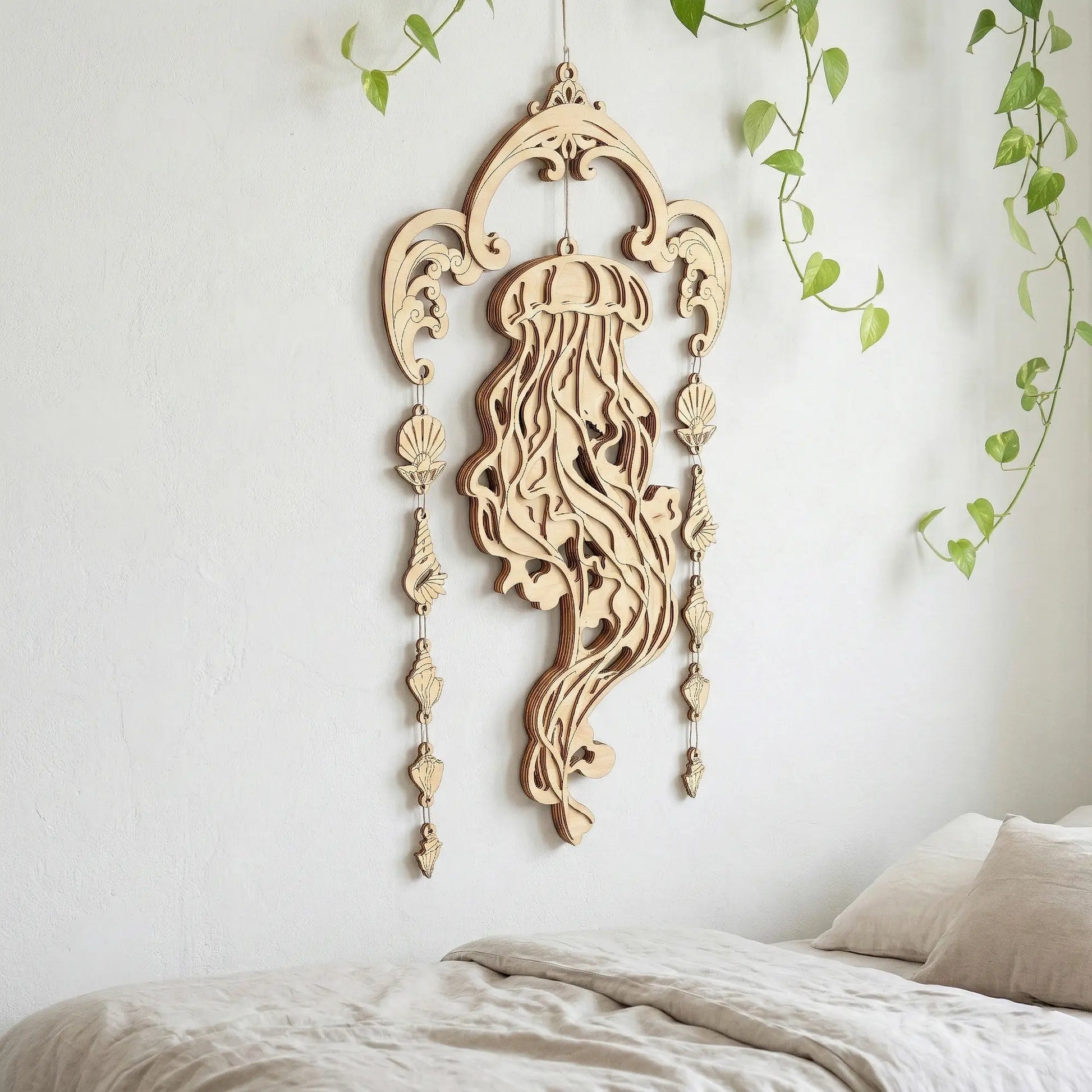 Decorative wooden laser cut wall hanging with intricate design on a white wall.
