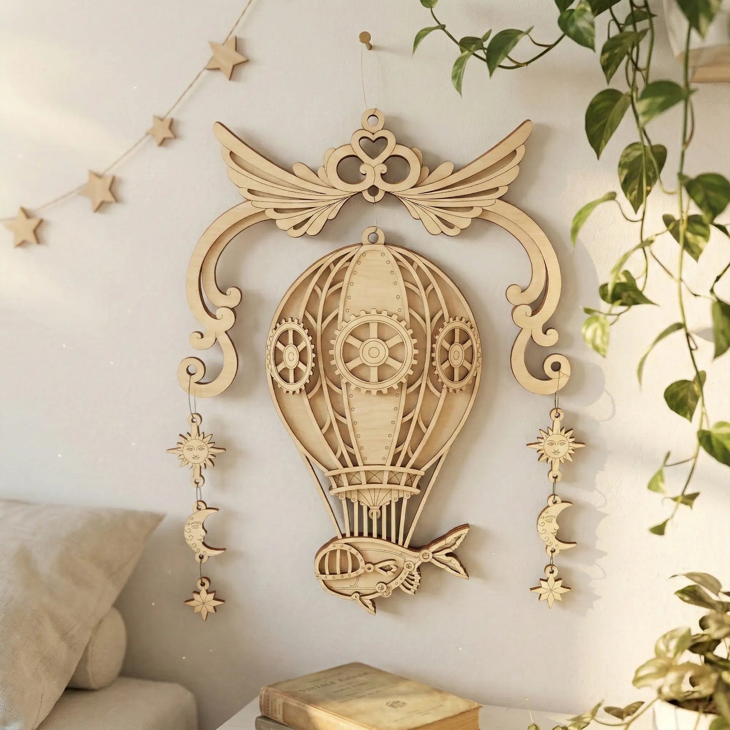 Decorative laser cut hot air balloon wall hanging with intricate details on a light-colored wall.