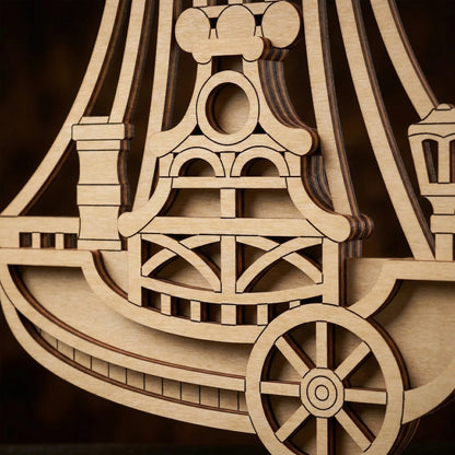 Wooden laser cut of a ship with intricate details on a dark background