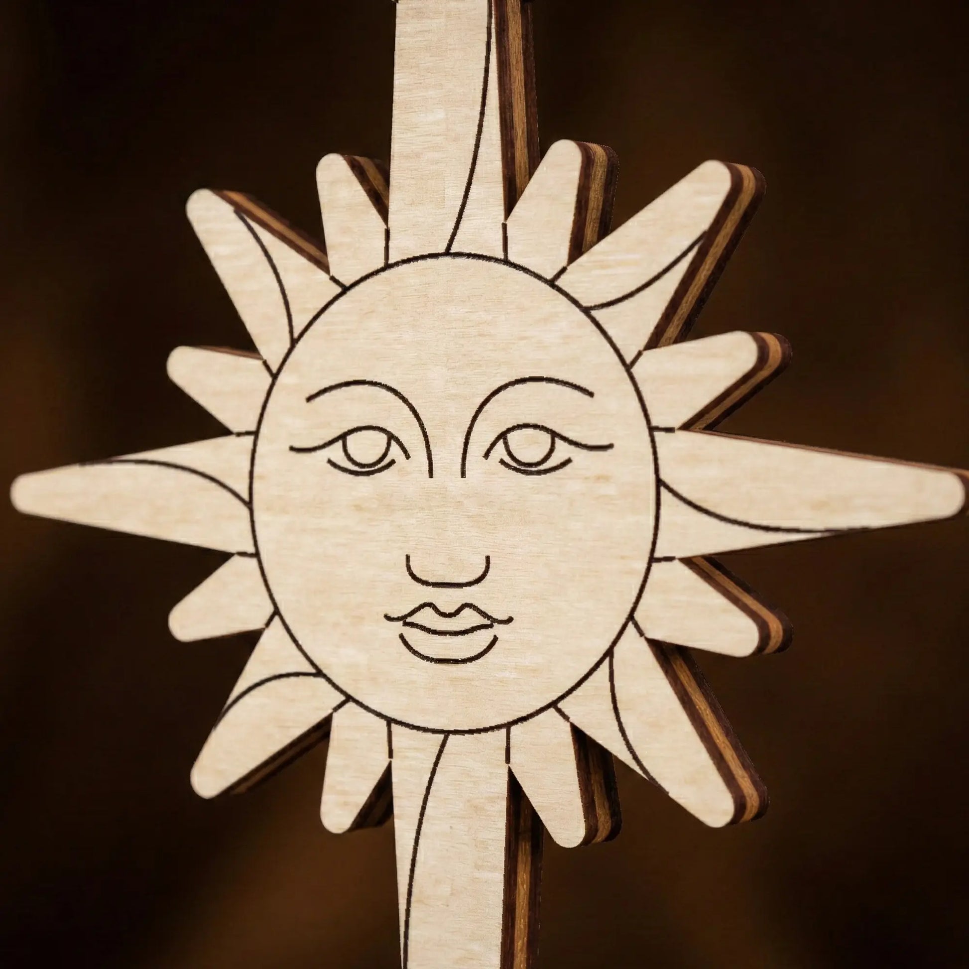 laser cut  sun-shaped ornament with face on a dark background