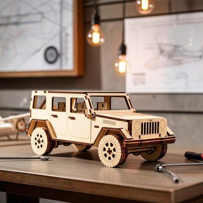 Laser cut wooden off-road vehicle model on a workbench with wrenches and blueprints. Detailed 3D puzzle with a vertical grille, large treaded tires, and open windows. Precise dark edges from laser cutting on natural light plywood.