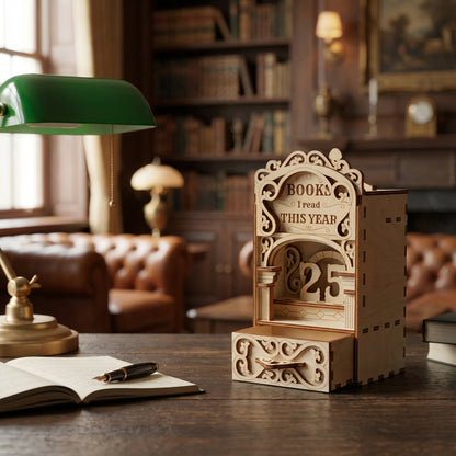 Laser cut book nook digital file displayed on a desk with an open book and lamp, showing a wooden reading tracker bookshelf insert.