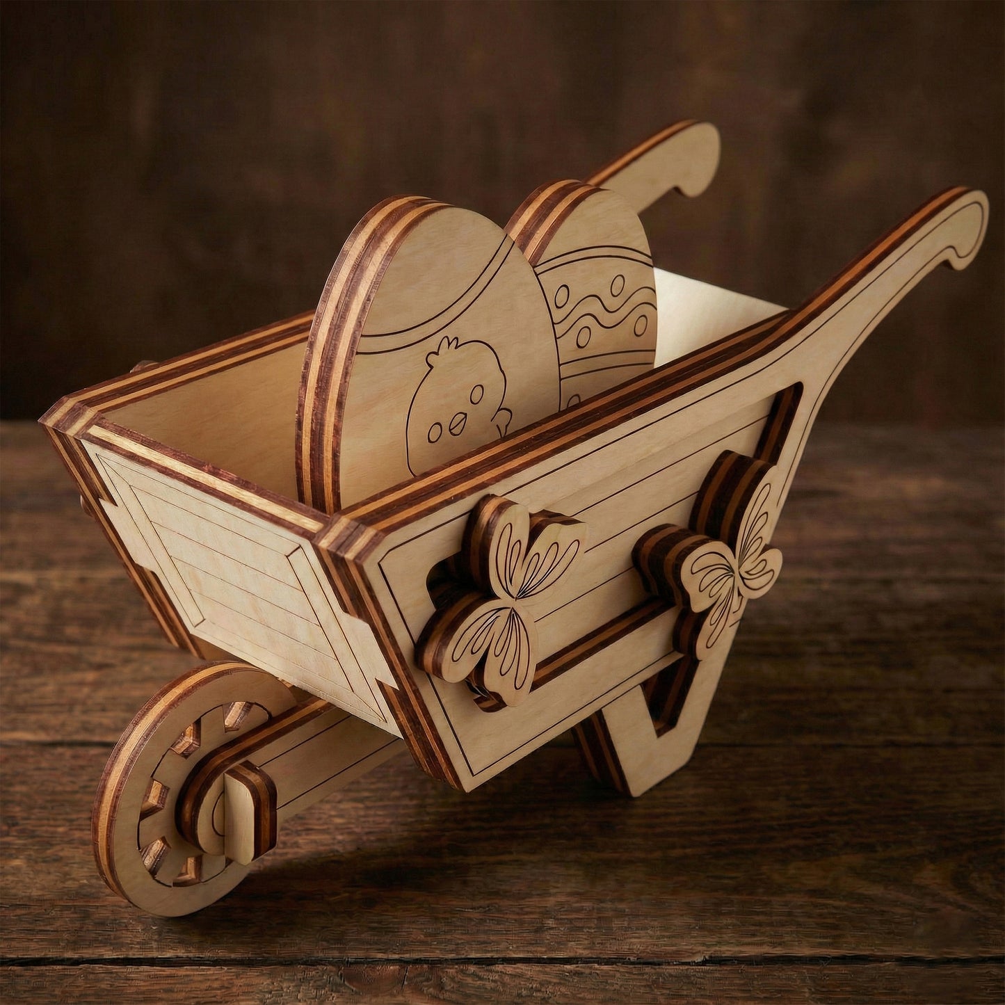 Wooden laser cut wheelbarrow with decorative elements on a wooden surface