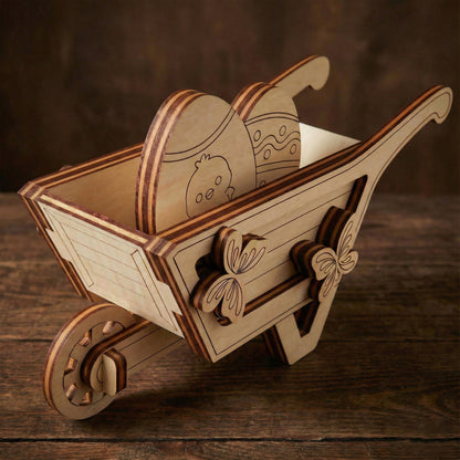 Wooden laser cut wheelbarrow with decorative elements on a wooden surface