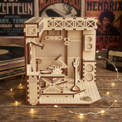 Wooden laser cut model of a music-themed set on a wooden surface with records in the background