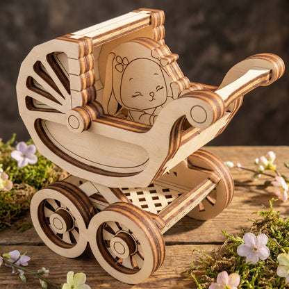 Wooden laser cut toy pram with a bear design on a wooden surface with flowers