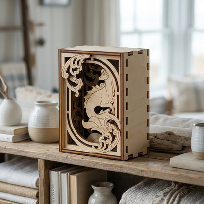 Wooden decorative laser cut box with intricate cut-out design on a wooden shelf.