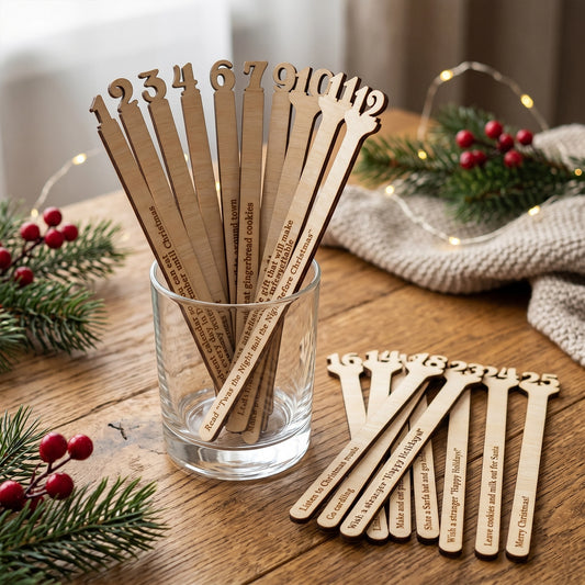 Laser cut plywood Christmas activity advent calendar sticks with engraved numbers 1 to 25, arranged on a grey wooden board.