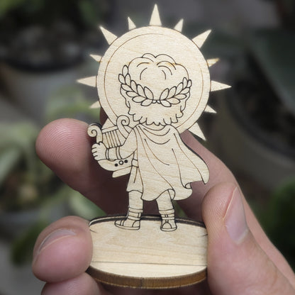 Back view of a laser cut plywood Apollo held in hand. Highlights the dark burnt wood edges and natural plywood grain texture