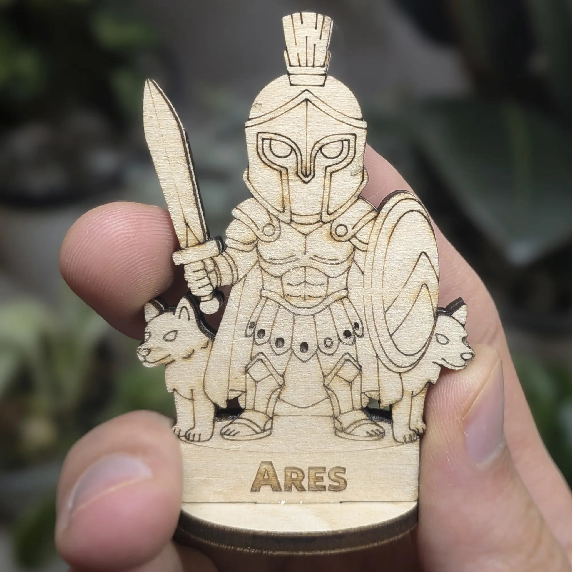 Hand holds a laser cut plywood Ares for scale. Detailed front showing the spear, helmet plume, and engraved Greek shield