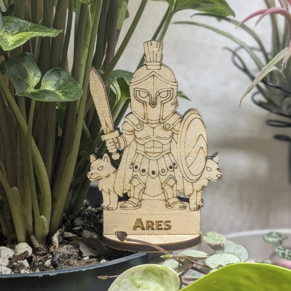 Laser cut plywood Ares figurine in a plant pot. Features a plumed helmet, spear, and round Greek shield on wood base