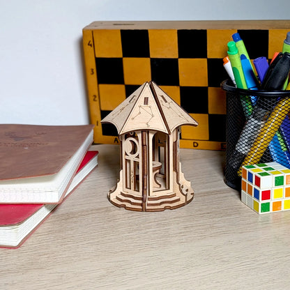 An aesthetic lifestyle shot of a miniature astronomical gazebo made from laser cut plywood, styled beautifully on a table.